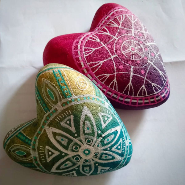 two painted hearts with abstract mandala patterning