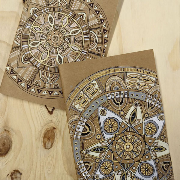 notebooks covered in mandala pattterned art