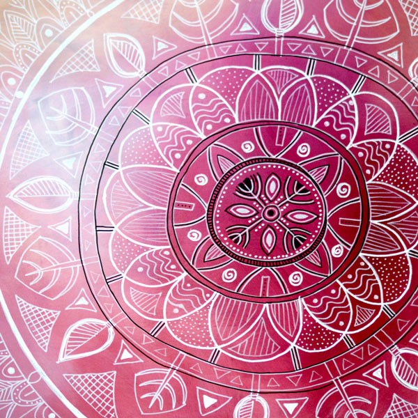 a closeup of one of Mandy Evans Artists sacred mandala paintings with an pinky magenta abstract background