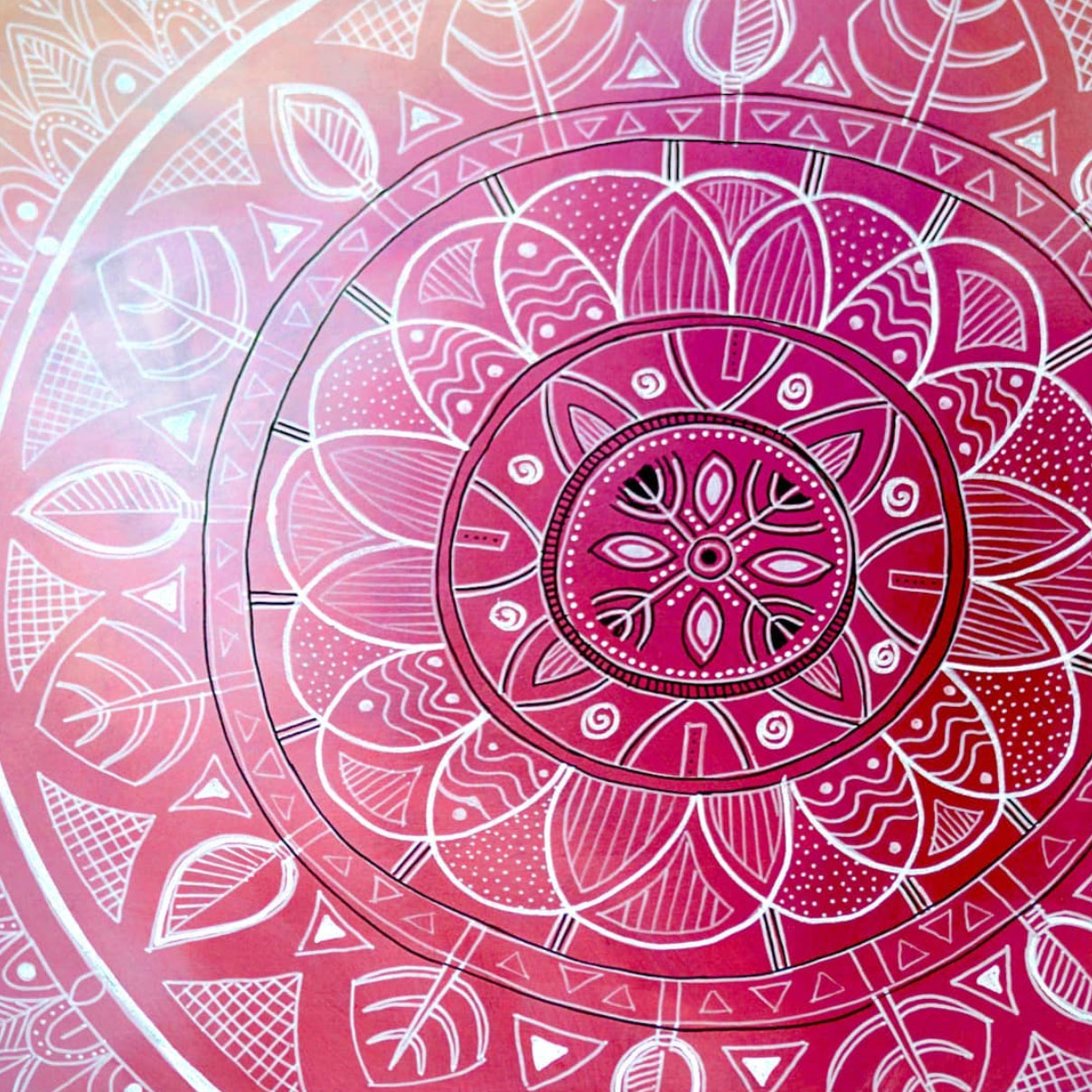 a magenta coloured background with a mandala pattern