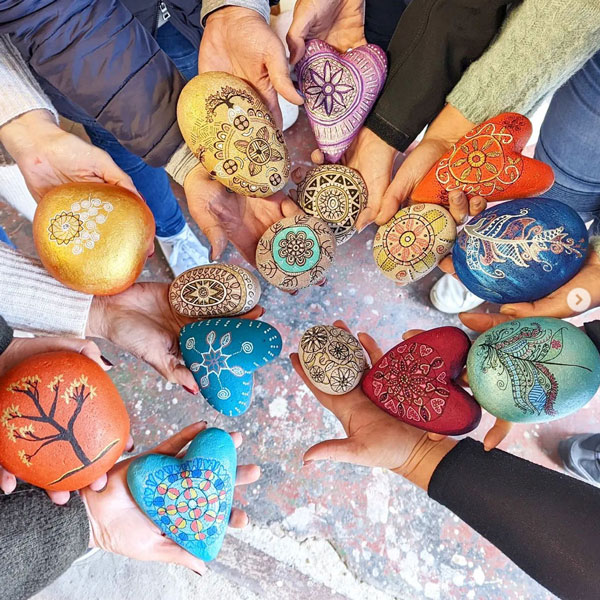 a gorgeous selection of painted rocks in a bowl