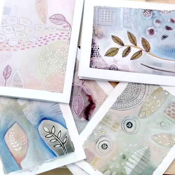 a closeup of notebooks painted in abstract watercolour