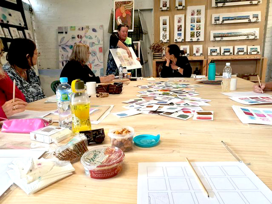 images of women at one of Mandys art workshops painting with acrylics and home made stamps