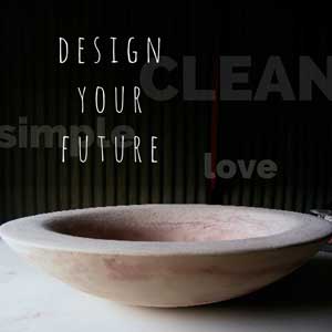 one of Mandys gorgeous cement bowls in a dramatic dark setting with the words - design your future